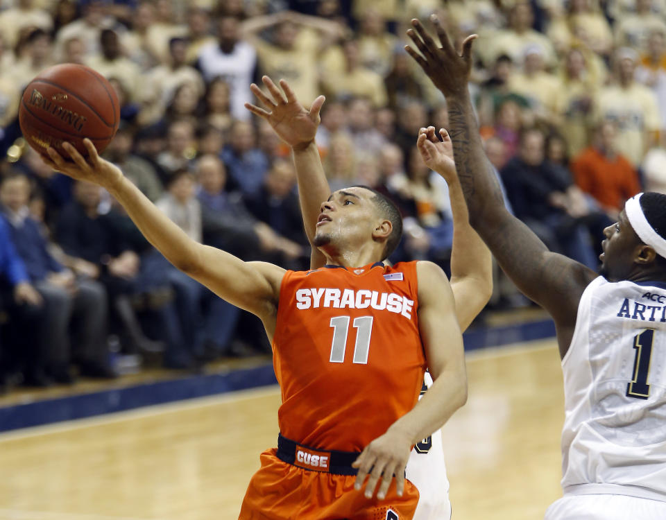 Syracuse's Tyler Ennis (11) shoots after getting past Pittsburgh's Jamel Artis (1) during the second half of an NCAA college basketball game Wednesday, Feb. 12, 2014, in Pittsburgh. (AP Photo/Keith Srakocic)