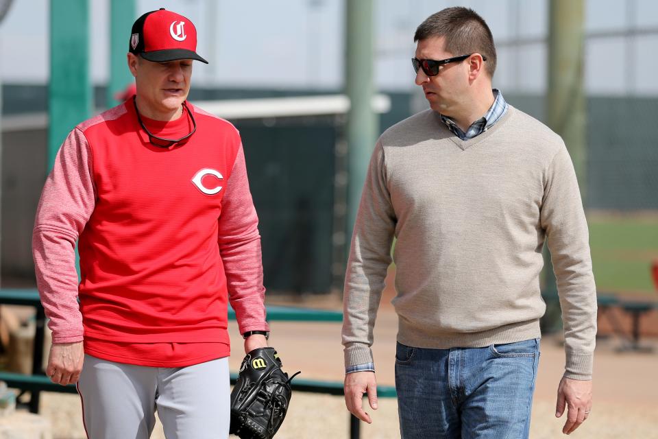Cincinnati Reds manager David Bell (25), left, talks with general manager Nick Krall, right, Cincinnati Reds pitchers and catchers work out, Friday, Feb. 15, 2019, at the Cincinnati Reds spring training facility in Goodyear, Arizona.