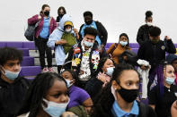 FILE - Students wearing mask as a precaution against the spread of the coronavirus line up to receive KN95 protective masks at Camden High School in Camden, N.J., Feb. 9, 2022. U.S. COVID-19 cases are up, leading a smattering of school districts, particularly in the Northeast, to bring back mask mandates and recommendations for the first time since the omicron winter surge ended and as the country approaches 1 million deaths in the pandemic. (AP Photo/Matt Rourke, File)