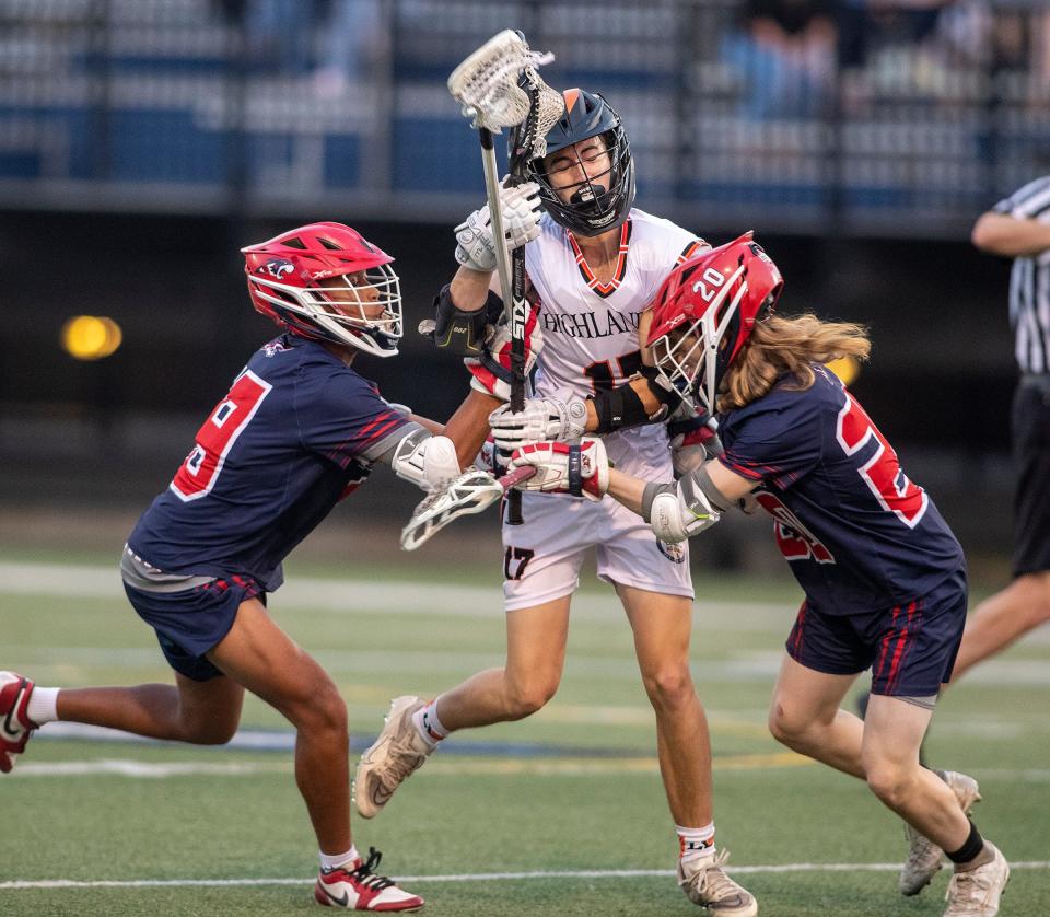 Lake Wales's Luke Weaver (17) attempts to split two All Saints defenders during the Boys Class 1A, District 6 championship lacrosse game in Lakeland on Wednesday.