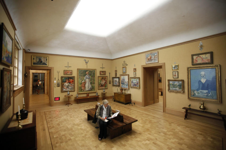 A visiter sits in gallery 18 during a preview of The Barnes Foundation Wednesday, May 16, 2012, in Philadelphia. After years of bitter court fights, the Barnes Foundation is scheduled to open its doors to the public on May 19 at its new location on Philadelphia's "museum mile." (AP Photo/Matt Rourke)