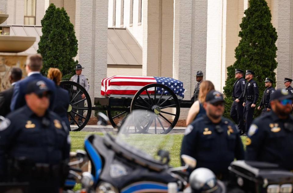 A horse-drawn carriage carries the body of officer Joshua Eyer to First Baptist Church on Friday, May3, 2024. Officer Eyer was killed while serving a warrant in east Charlotte on Monday, April 29, 2024