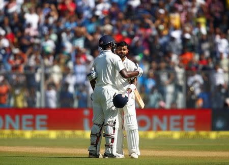 Cricket - India v England - Fourth Test cricket match - Wankhede Stadium, Mumbai, India - 11/12/16. India's Virat Kohli (R) celebrates with his team mate Jayant Yadav his double century. REUTERS/Danish Siddiqui