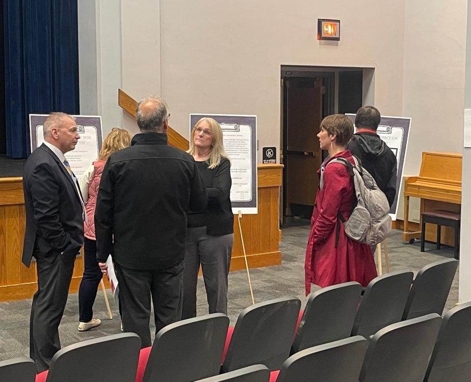 Conemaugh Township Area School District board members Jeffrey Alesantrino, left, and Susan Saylor-Stahl, center, talk with residents about the district's three-year renovation project and accompanying tax increase. Alesantrino is treasurer of the school board and Saylor-Stahl is the board president.