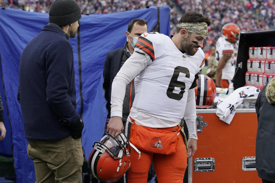 Cleveland Browns quarterback Baker Mayfield (6) walks out of the medical tent after being examined during the second half of an NFL football game against the New England Patriots, Sunday, Nov. 14, 2021, in Foxborough, Mass. (AP Photo/Steven Senne)