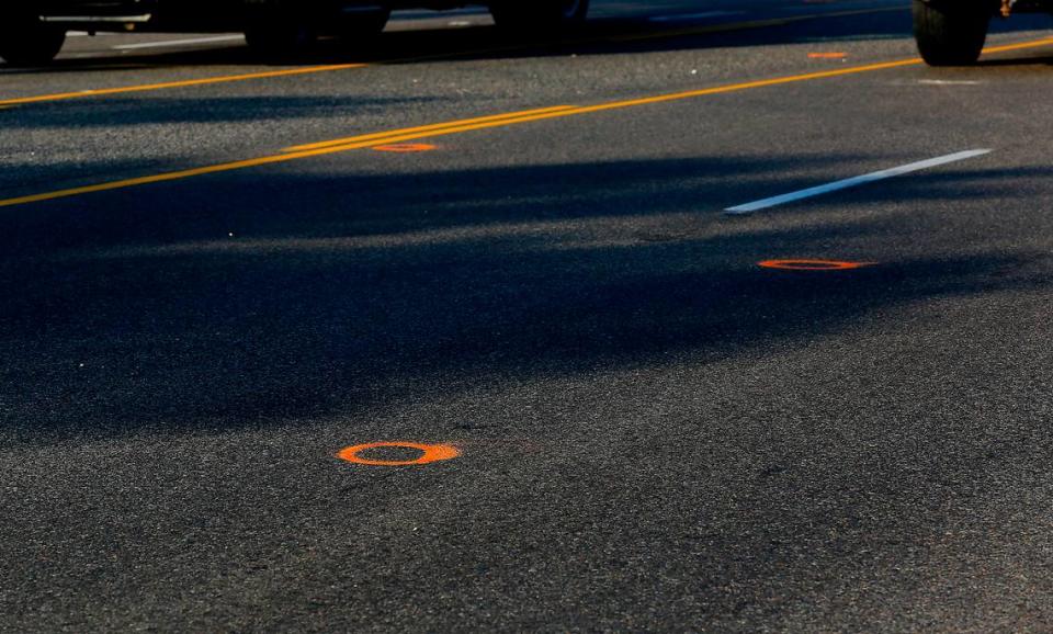 Traffic drives past multiple police investigation evidence paint circles on Highway 397 where Jatzivy Sarabia, 18, was apparently killed on Oct. 15, 2022 when shots were fired into the car she was riding in, according to the Benton County Sheriff’s Office. Law enforcement officials believe that the deadly confrontation between two cars started about 11:40 p.m., when gunfire was reported on or near Highway 397, also called Chemical Drive.