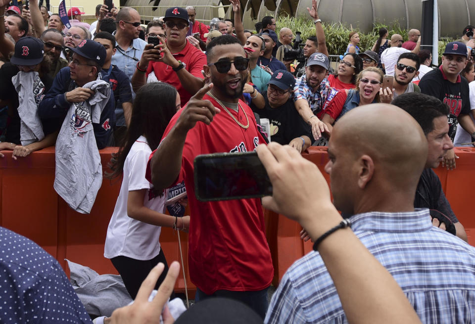CORRECTS NAME OF RED SOX PLAYER - Boston Red Eduardo Nunez arrives at Alex Cora's Puerto Rican hometown with the 2018 World Series trophy, accompanied by Chairman Tom Werner and President and CEO Sam Kennedy, as well as seven Red Sox players and coaches, in Caguas, Puerto Rico, Saturday, Nov. 3, 2018. (AP Photo Carlos Giusti)
