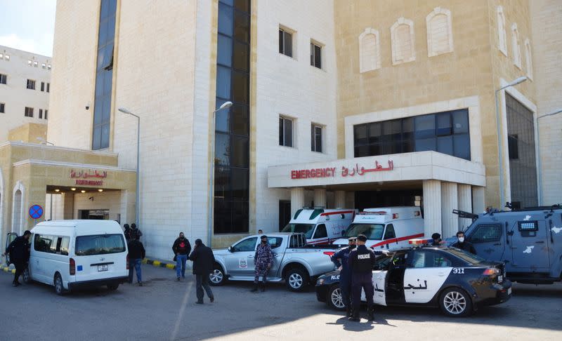 Police officers stand outside the new Salt government hospital in the city of Salt