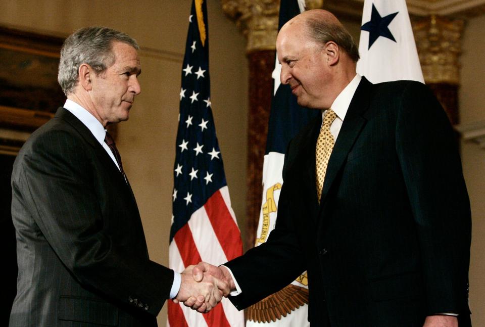 President Bush, left, shakes hands with Deputy Secretary of State John Negroponte, right, after he was ceremonially sworn in at the State Department in Washington Tuesday Feb. 27, 2007.