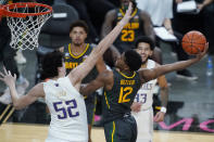 Baylor's Jared Butler (12) attempts a shot over Washington's Riley Sorn (52) during the second half of an NCAA college basketball game Sunday, Nov. 29, 2020, in Las Vegas. (AP Photo/John Locher)