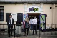 People queue at the entrance of a pooling station during general elections in Gibraltar, Thursday Oct. 17, 2019. An election for Gibraltar's 17-seat parliament is taking place Thursday under a cloud of uncertainty about what Brexit will bring for this British territory on Spain's southern tip.(AP Photo/Javier Fergo)