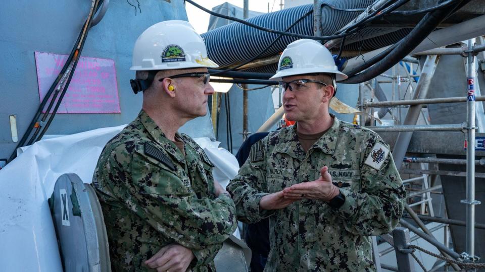 Rear Adm. William Greene, left, the commander of Navy Regional Maintenance Center, and Capt. Paul Murch, the Forward Deployed Regional Maintenance Center Detachment Rota officer in charge, review work on the destroyer Roosevelt during a planned maintenance period in Rota, Spain. (Petty Officer 2nd Class Drace Wilson/U.S. Navy)