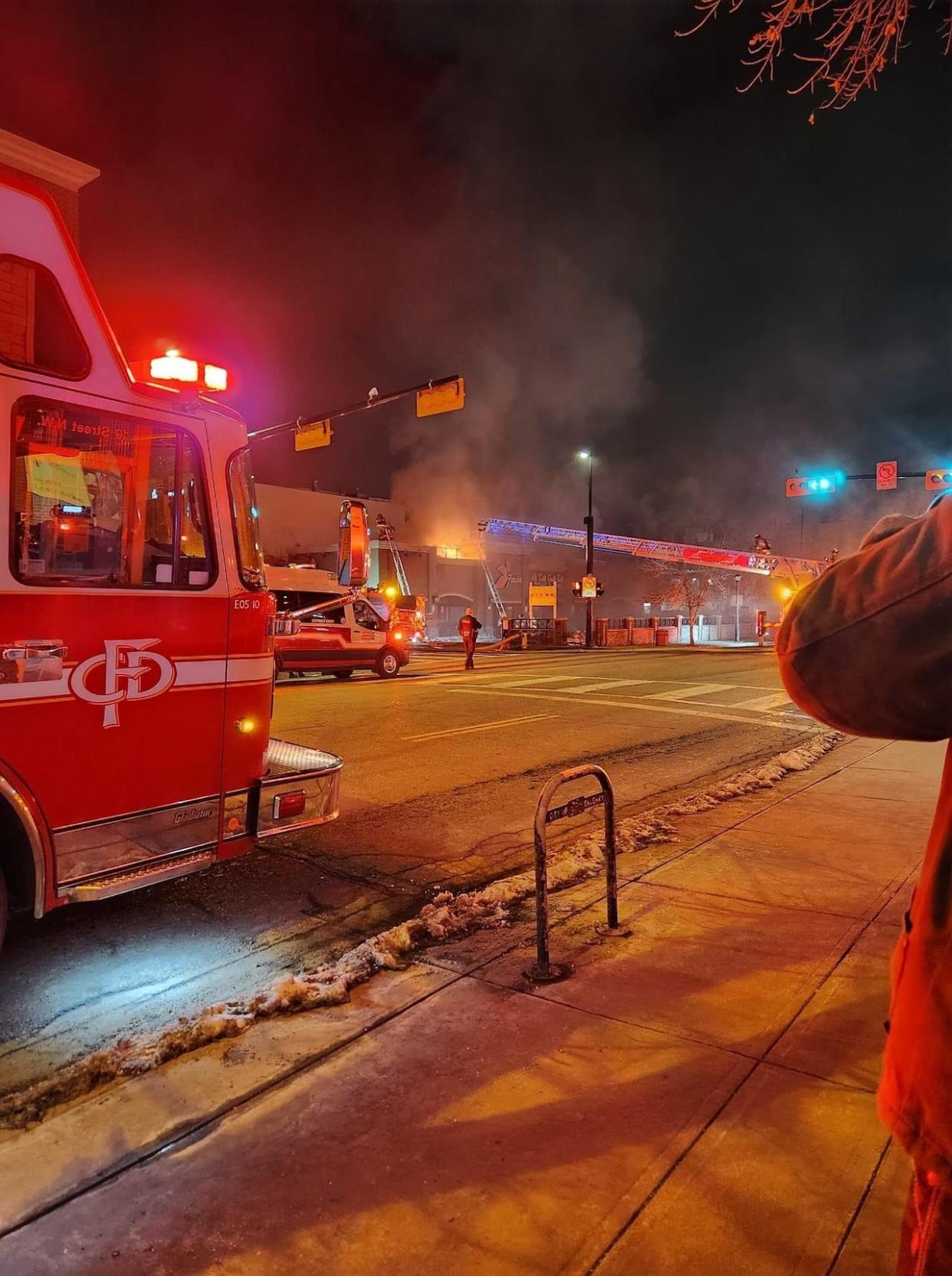 Crews battled a roof fire at a restaurant building in Kensington in northwest Calgary on Monday night.  (Cassandra Stacey/Facebook - image credit)