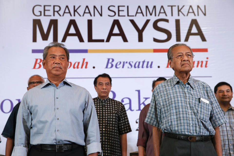 FILE - In this March 27, 2016, file photo, Malaysia's former Prime Minister Mahathir Mohamad, right, and former Deputy Prime Minster Muhyiddin Yassin attend the "People's Congress 2016" event in Shah Alam, Malaysia. Malaysian ex-Prime Minister Mahathir has been ousted from his Malay party in the latest twist to a power struggle with his successor Muhyiddin Yassin, but he has vowed to challenge it. (AP Photo/Vincent Thian, File)