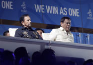 Brunei's Sultan Hassanal Bolkiah, left, sits beside Philippine President Rodrigo Duterte during the opening ceremony of the 30th South East Asian Games at the Philippine Arena, Bulacan province, northern Philippines on Saturday, Nov. 30, 2019. (AP Photo/Aaron Favila)