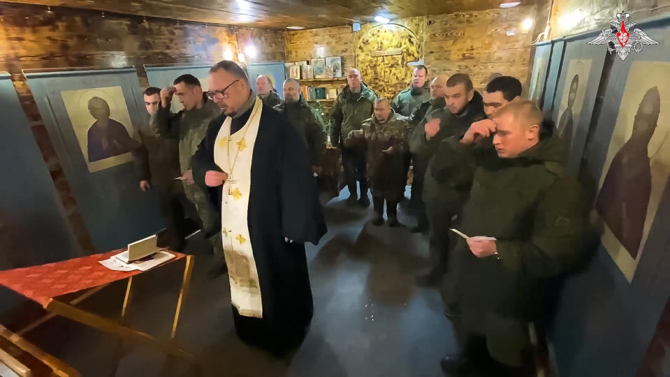 In this photo taken from a video released by the Russian Defense Ministry Press Service on Sunday, Jan. 7, 2024, A Russian Orthodox Church priest conducts an Orthodox Christmas service for servicemen on a mission during a special military operation in Ukraine. (Russian Defense Ministry Press Service via AP)