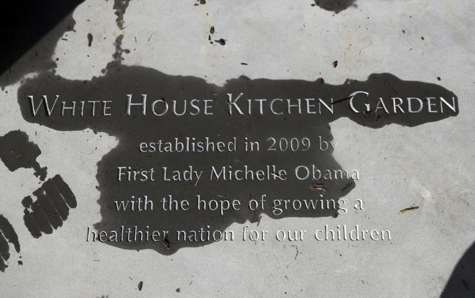 FILE - In this Oct. 5, 2016 file photo, a new paver etched with markings "White House Kitchen Garden" is seen at the entrance to the White House Kitchen Garden at the White House in Washington. What does Michelle Obama do next After eight years as a high-profile advocate against childhood obesity, a sought-after talk show guest, a Democratic power player and a style maven, the first lady will have her pick of options when she leaves the White House next month. (AP Photo/Manuel Balce Ceneta, File)