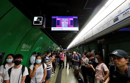Passengers wait for the resumption of Mass Transit Railway (MTR) services during a disruption by protesters at Fortress Hill station in Hong Kong