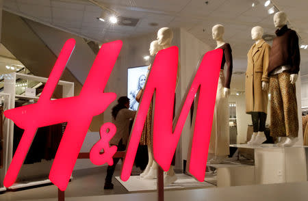 FILE PHOTO: The logo of H&M is seen in a display window of a store in Zurich, Switzerland January 7, 2019. REUTERS/Arnd Wiegmann/File Photo