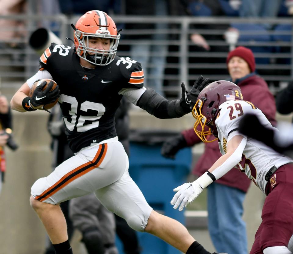 Irontons Lincoln Barnes slips the tackle of South Range's Tristan Toy in the first quarter of Ironton South Range in the OHSAA Division V State Championship football game at Tom Benson Hall of Fame Stadium.  Friday, December 02, 2022.