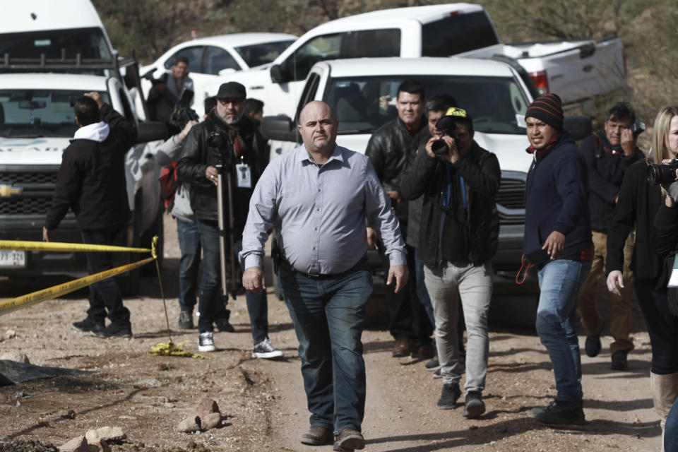 Julian Le Baron arrives where one of the cars belonging to the extended LeBaron family was ambushed by gunmen last year near Bavispe, Sonora state, Mexico, Sunday Jan. 12, 2020. Lopez Obrador said Sunday there is an agreement to establish a monument will be put up to memorialize nine U.S.-Mexican dual citizens ambushed and slain last year by drug gang assassins along a remote road near New Mexico. (AP Photo/Christian Chavez)