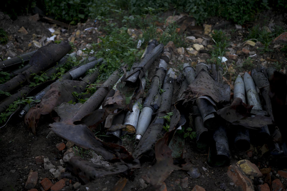 Unexploded shells and other weaponry lay beside a road near Makariv, on the outskirts of Kyiv, Ukraine, Tuesday, June 14, 2022. Russia’s invasion of Ukraine is spreading a deadly litter of mines, bombs and other explosive devices that will endanger civilian lives and limbs long after the fighting stops. (AP Photo/Natacha Pisarenko)