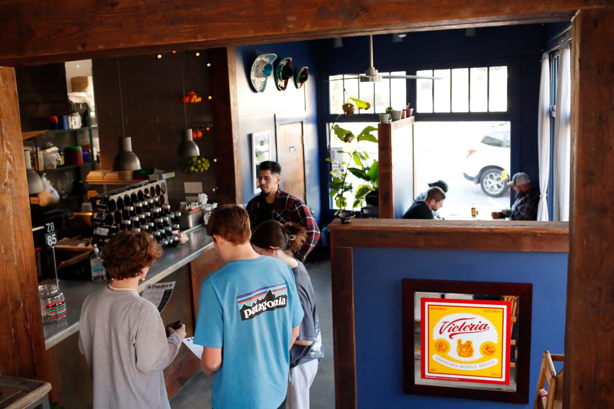 Customers line up to order at Poquitos located in the former Go Bar on Prince Avenue. 