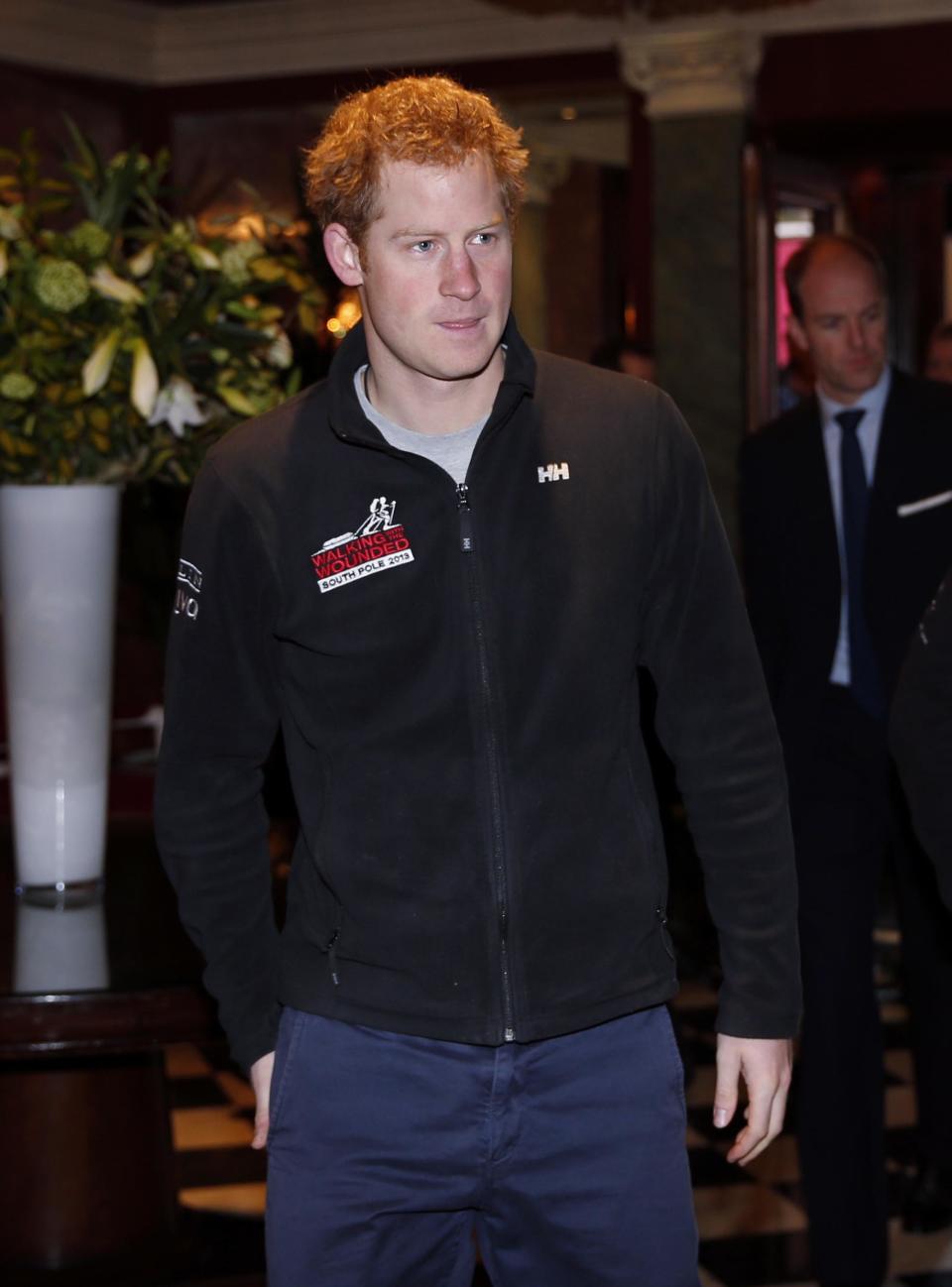 Britain's Prince Harry, the Expedition Patron, arrives for a welcome home news conference for the members of the Walking With The Wounded South Pole Allied Challenge 2013 team, in central London, Tuesday, Jan. 21, 2014. The Walking With The Wounded Virgin Money South Pole Allied Challenge 2013 concluded on Friday 13 December, when three teams of wounded servicemen and women successfully reached the South Pole after crossing 200km of Antarctic plateau. (AP Photo/Lefteris Pitarakis, Pool)