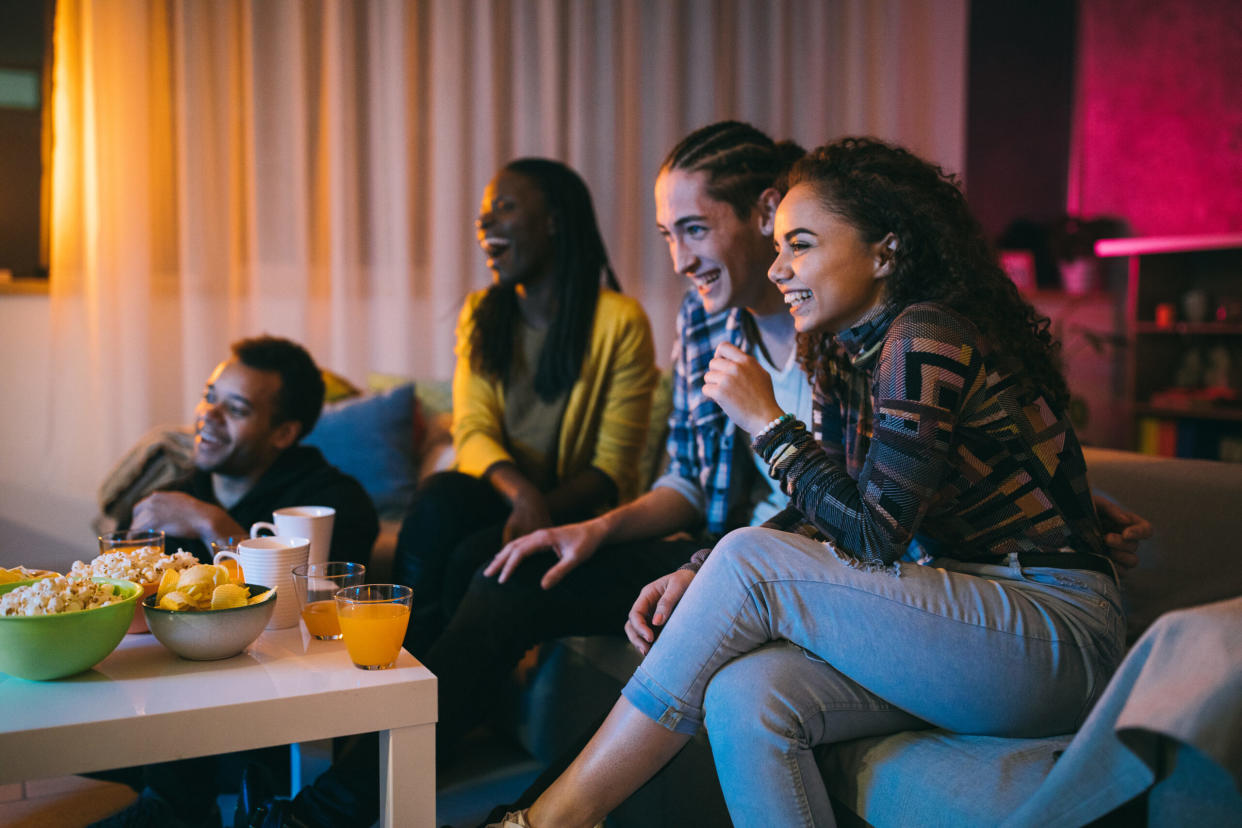 Friends watching comedy movie at home | 