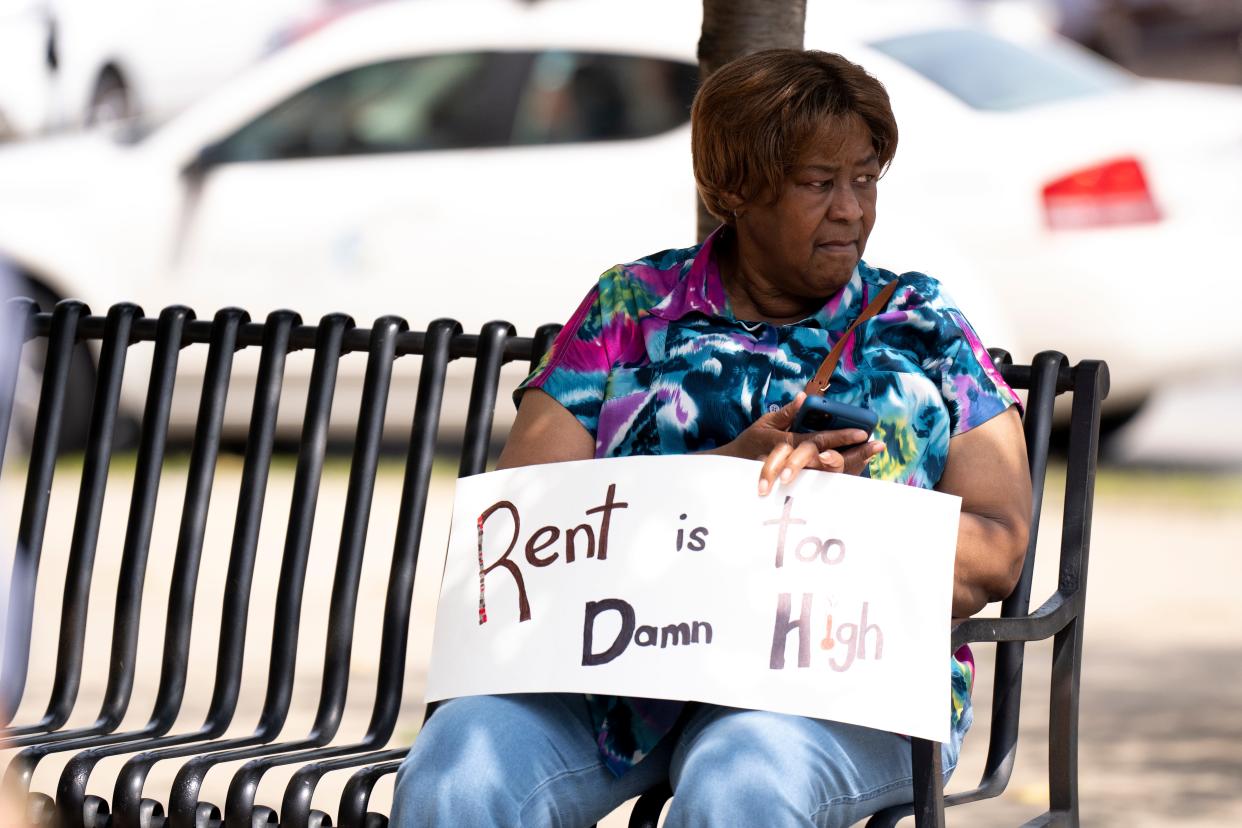 Cincinnati resident Ella Adams holds a sign during a rally addressing affordable housing at Cincinnati City Hall on Aug. 2. Nearly 12,000 residents signed Cincinnati Action for Housing Now’s petition to put an issue on November’s ballot to amend the city charter to increase the earned income tax from 1.8% to 2.1% to support affordable housing efforts.