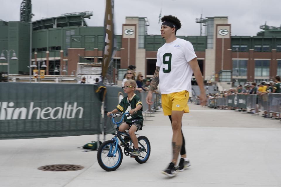 Green Bay Packers' Christian Watson walks to the NFL football team's practice field Wednesday, July 27, 2022, in Green Bay, Wis. (AP Photo/Morry Gash)