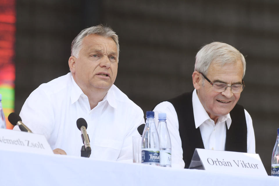 Hungarian Prime Minister Viktor Orban, left, speaks as President of the Hungarian National Council of Transylvania Laszlo Tokes looks on at the 30th Balvanyos Summer University and Students' Camp in Baile Tusnad, Transylvania, Romania, Saturday, July 27, 2019. (Szilard Koszticsak/MTI via AP)