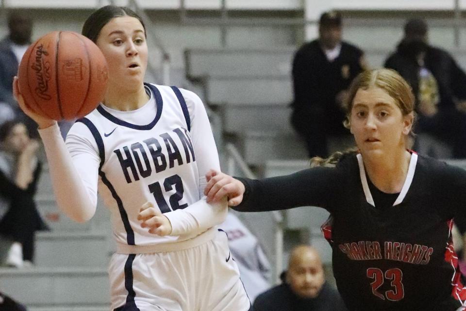 Hoban's Finley Kennedy keeps the ball inbounds as Shaker Heights' Cece Favret defends in a Division I district semifinal Feb. 21, 2-223, at Perry High School.