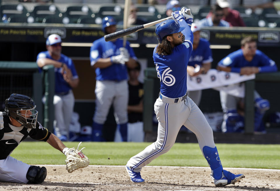 Toronto Blue Jays' Bo Bichette watches his two-run home run off Pittsburgh Pirates relief pitcher Matt Eckelman during the fourth inning of a spring training baseball game Friday, March 8, 2019, in Bradenton, Fla. Catching for the Pirates is Jacob Stallings. (AP Photo/Chris O'Meara)