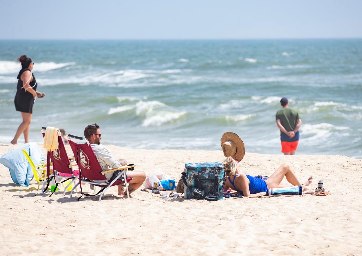 Families and friends gather at St. George Island beach as many enjoy their spring break vacations Thursday, March 25, 2021.