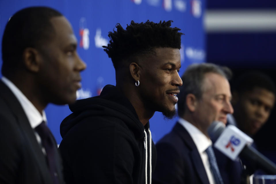 Philadelphia 76ers' Jimmy Butler, center left, speaks with members of the media during a news conference at the NBA basketball team's practice facility in Camden, N.J., Tuesday, Nov. 13, 2018. Butler is accompanied by general manager Elton Brand, left, owner Josh Harris, and player Justin Patton. (AP Photo/Matt Rourke)