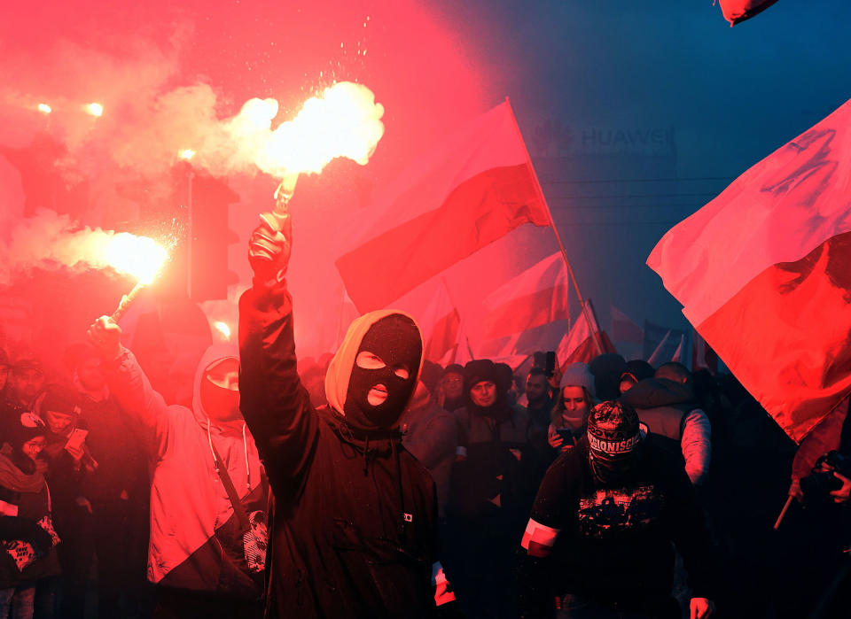 <p>Demonstrators burn flares and wave Polish flags during the annual march to commemorate Poland’s National Independence Day in Warsaw on Nov. 11, 2017. (Photo: Janek Skarzynski/AFP/Getty Images) </p>