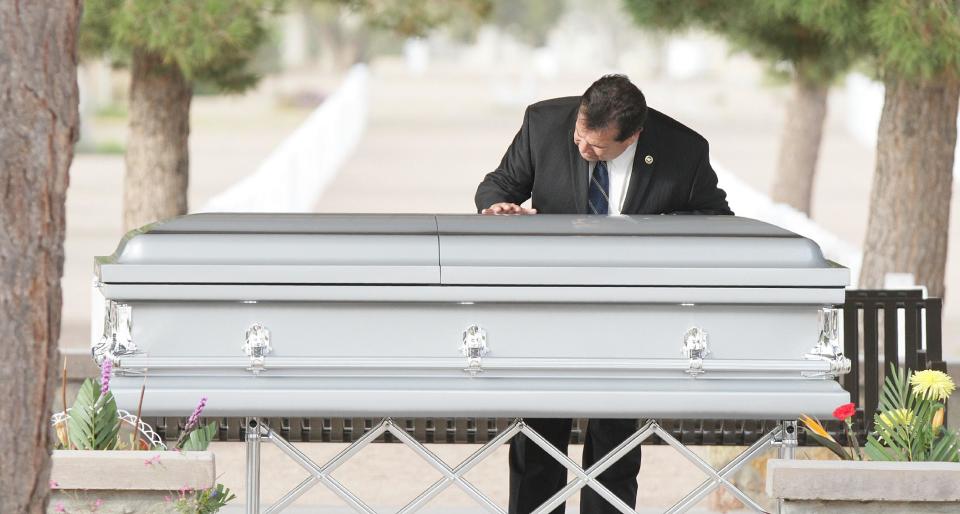 CORRECTS DATE - An unidentified man touches the casket Sherman Hemsley who was buried at the Fort Bliss National Cemetery, Wednesday, Nov. 21, 2012 in Fort Bliss, Texas. Friends and family remembered Hemsley at his funeral service in Texas by showing video clips of his best known role as George Jefferson on the TV sitcom "The Jeffersons." He died in July but a fight over his estate has delayed his burial. (AP Photo/The El Paso Times, Mark Lambie) EL DIARIO OUT; JUAREZ MEXICO OUT AND EL DIARIO DE EL PASO OUT