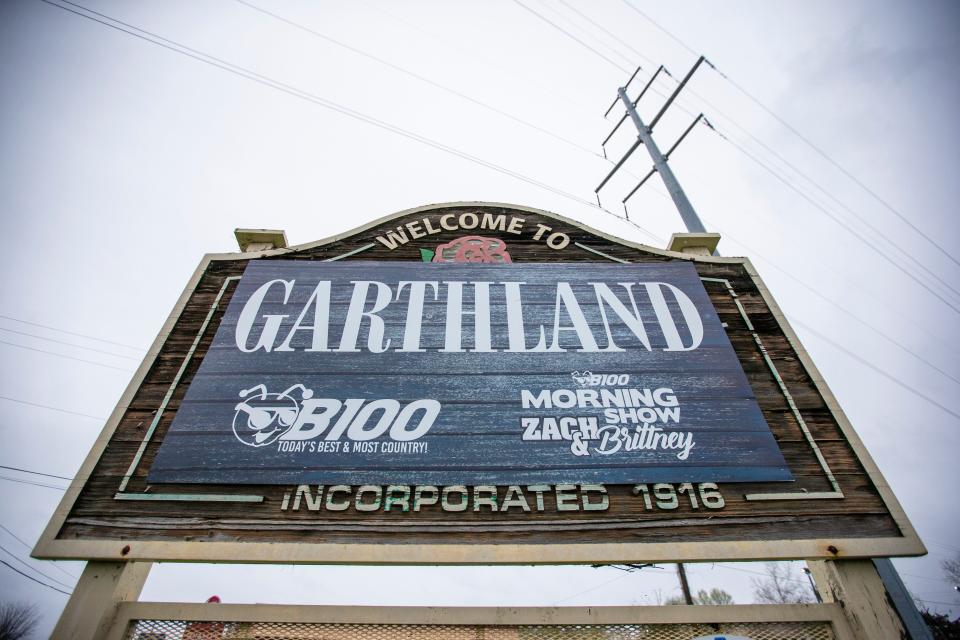 The "Welcome to Roseland" sign with a promotional "Welcome to Garthland" poster over it on Ind. 933 Friday.