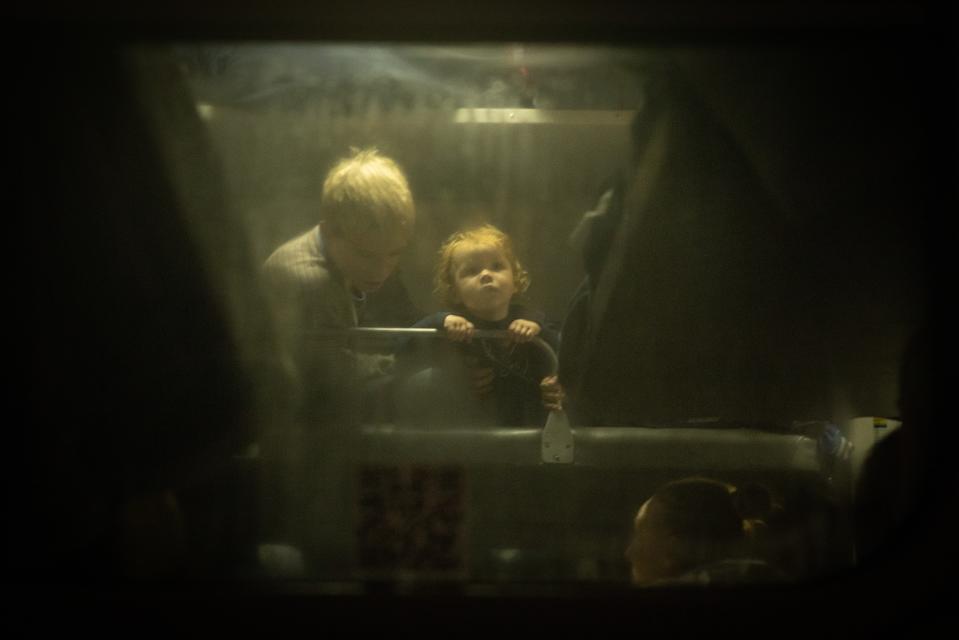 A child looks out from a bunk bed on board an evacuation train in Kherson, Ukraine. Infrastructure in the region remains heavily damaged. (Getty Images)