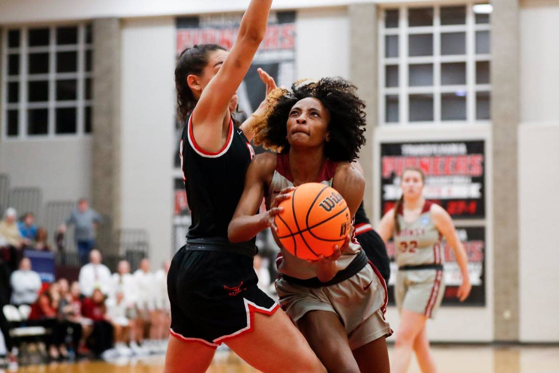 Transylvania’s Dasia Thornton, right, shoots the ball against Rhodes during the first round of the NCAA Division III Tournament in Lexington on March 3. She has averaged 12.2 points and 9.8 rebounds per game during her senior season.