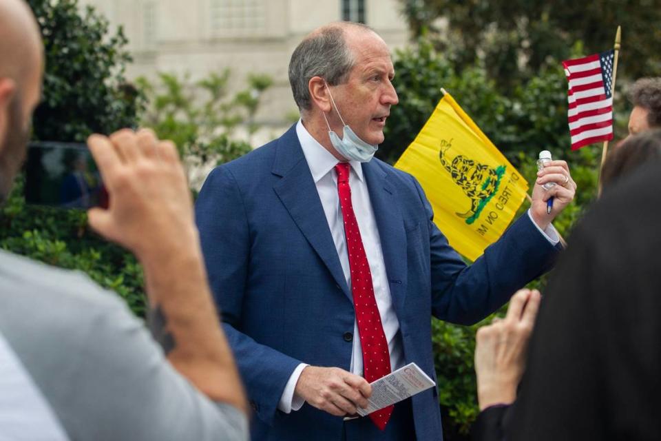 Rep. Dan Bishop holds a copy of the Constitution and a bottle of hand sanitizer while talking with constituents and reporters during a ReOpen NC protest in downtown Raleigh, N.C. Tuesday, April 21, 2020.