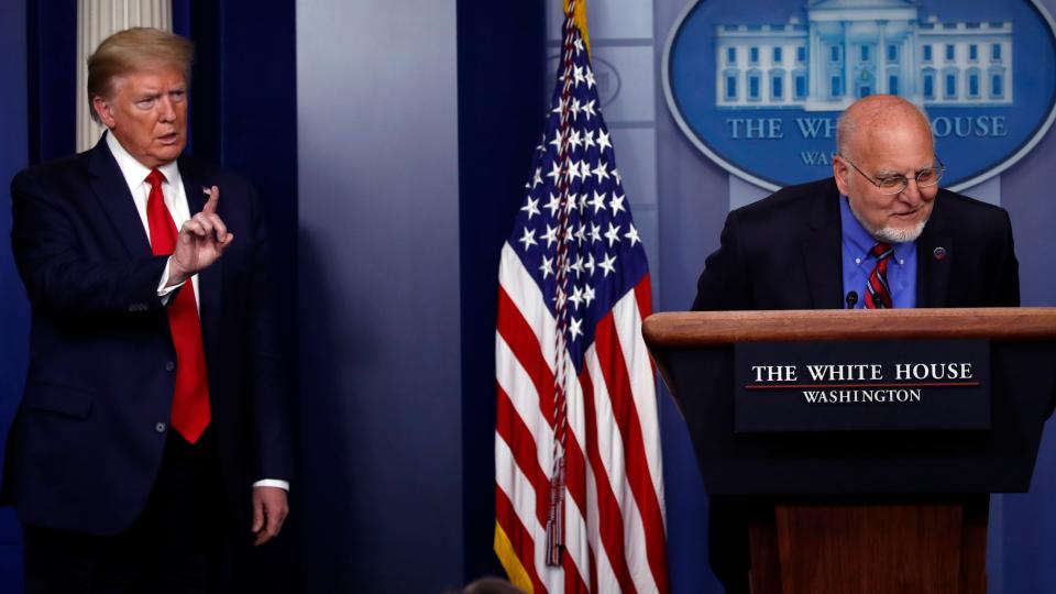 President Donald Trump listens as Dr. Robert Redfield speaks about the coronavirus in the White House press briefing room on April 22.