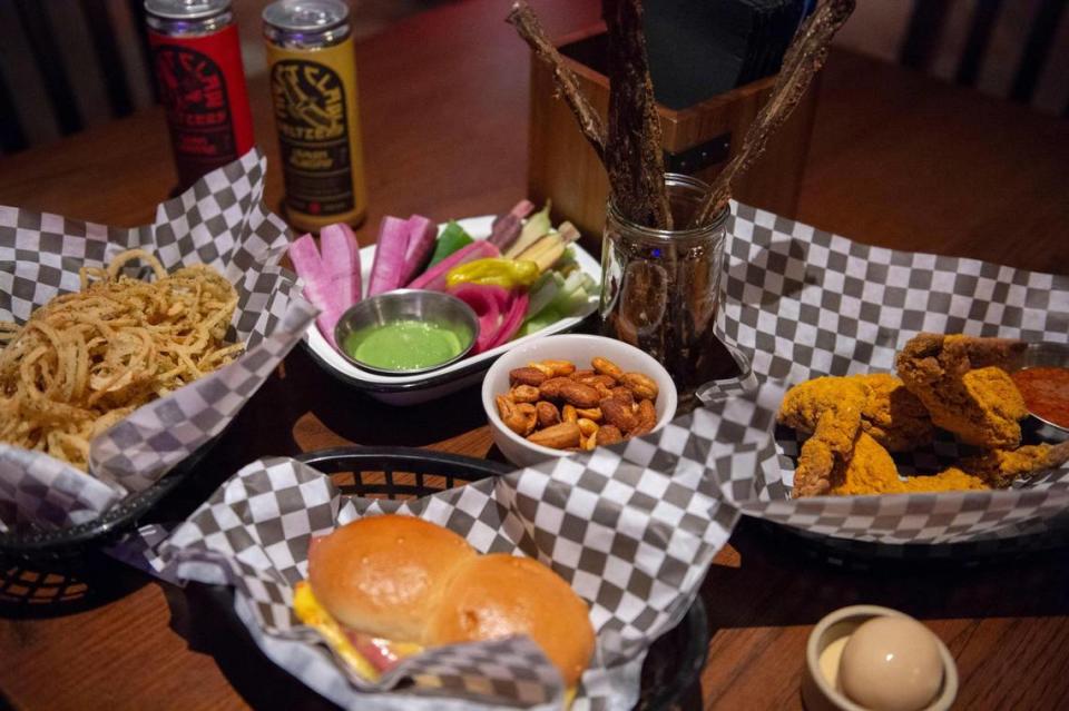 Some of the menu items at Nighthawk: Funny Onies, Veg N’ Dip, hot bologna buns, bar nuts, pepper jerky, fried mustard wings, and a smokey pickled egg.