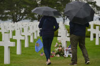 <p>Visitors view the graves of fallen soldiers at the Normandy American Cemetery, which contains the remains of 9,387 American military dead, most killed during the invasion of Normandy and ensuing military operations in World War II. (Photo: Artur Widak/NurPhoto via Getty Images) </p>