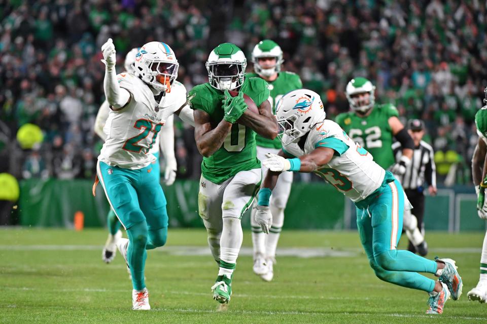 Oct 22, 2023; Philadelphia, Pennsylvania, USA; Philadelphia Eagles running back D'Andre Swift (0) carries the ball past Miami Dolphins safety DeShon Elliott (21) and cornerback Eli Apple (33) during the fourth quarter at Lincoln Financial Field. Mandatory Credit: Eric Hartline-USA TODAY Sports