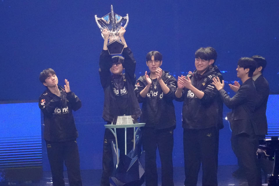 Members of team T1 celebrate with winners' trophy after winning the finals stage of the 2023 League of Legends World Championship between team T1 and team Weibo Gaming in Seoul, South Korea, Sunday, Nov. 19, 2023. South Korea’s esports powerhouse T1 won the world championship by defeating China-based Weibo Gaming. (AP Photo/Lee Jin-man)