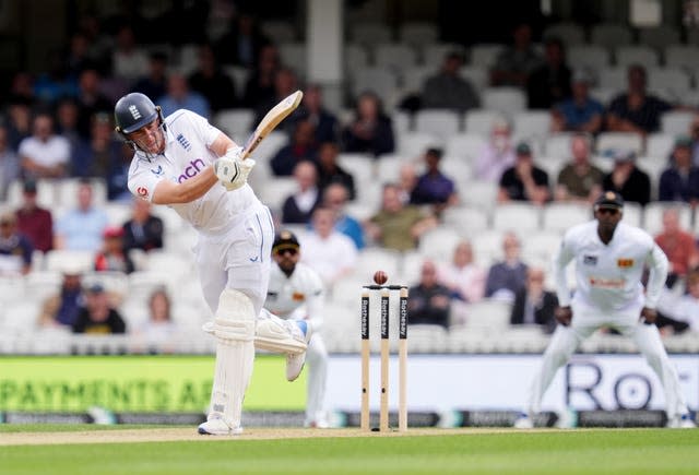 Dan Lawrence plays and misses as the ball passes past his legs and over the top of middle stump