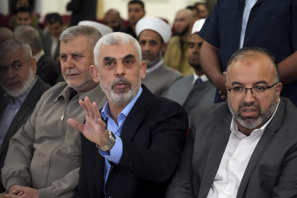 Yahya Sinwar, head of Hamas in Gaza, greets his supporters upon his arrival to a meeting with people at a hall on the sea side of Gaza City, Saturday, April 30, 2022. (AP Photo/Adel Hana)