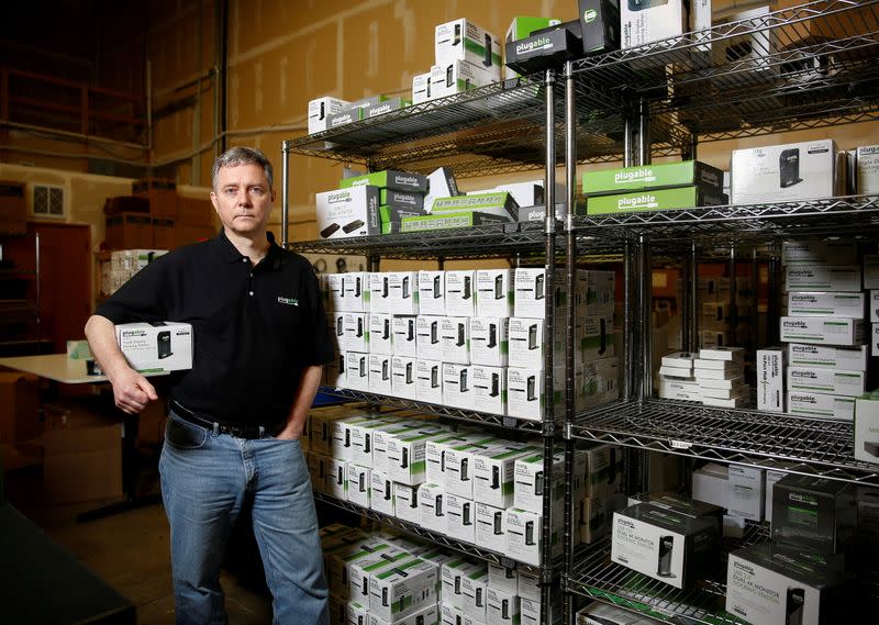 FILE PHOTO: Bernie Thompson of Plugable Technologies holds a docking station that he sells on Amazon.com